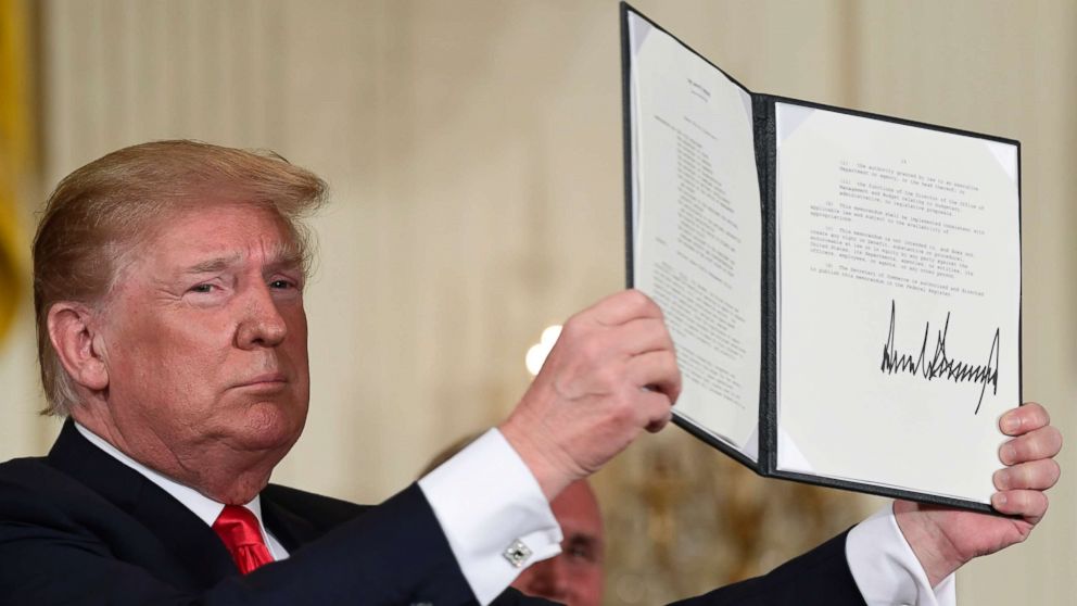 PHOTO: President Donald Trump holds up the space policy directive that he signed during a National Space Council meeting in Washington, June 18, 2018.