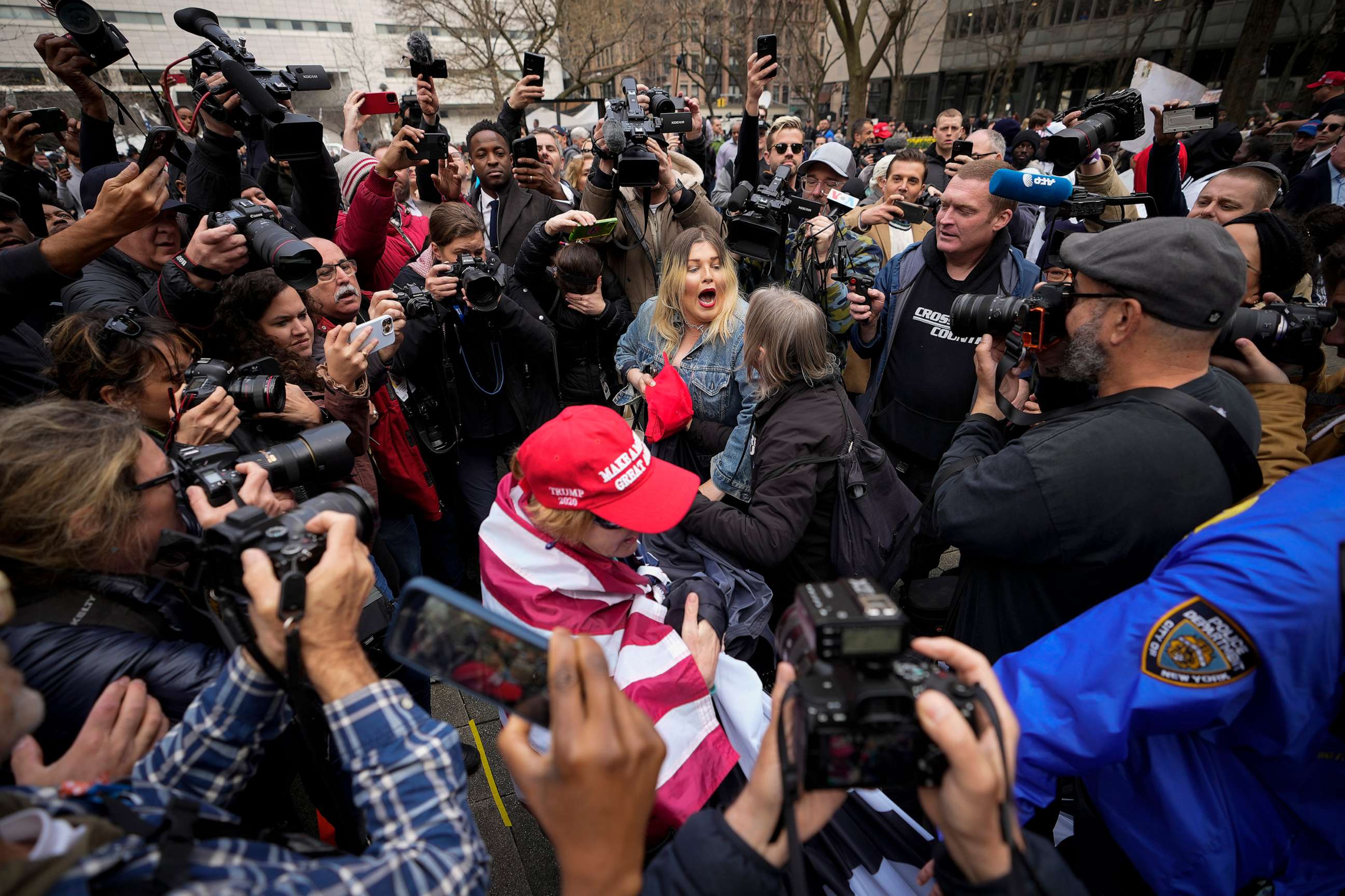 PHOTO: A supporter of former President Donald Trump scuffles with anti-Trump protesters outside the courthouse where Trump will arrive later in the day for his arraignment on April 4, 2023 in New York City.