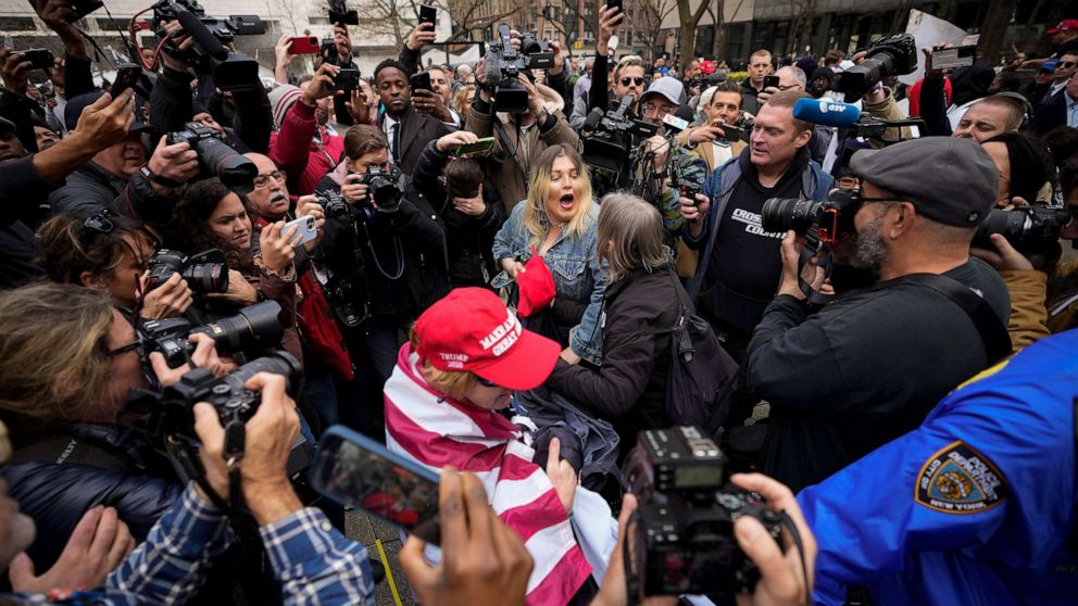 PHOTO: A supporter of former President Donald Trump scuffles with anti-Trump protesters outside the courthouse where Trump will arrive later in the day for his arraignment on April 4, 2023 in New York City.