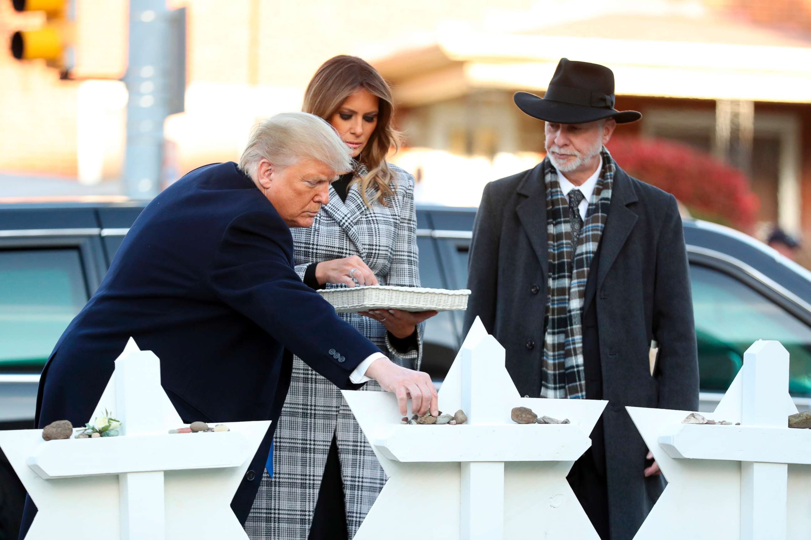 PHOTO: President Donald Trump and first lady Melania Trump put down stones from the White House at a memorial outside for those killed at the Pittsburgh's Tree of Life Synagogue in Pittsburgh, Oct. 30, 2018, as Tree of Life Rabbi Jeffrey Myers watches.