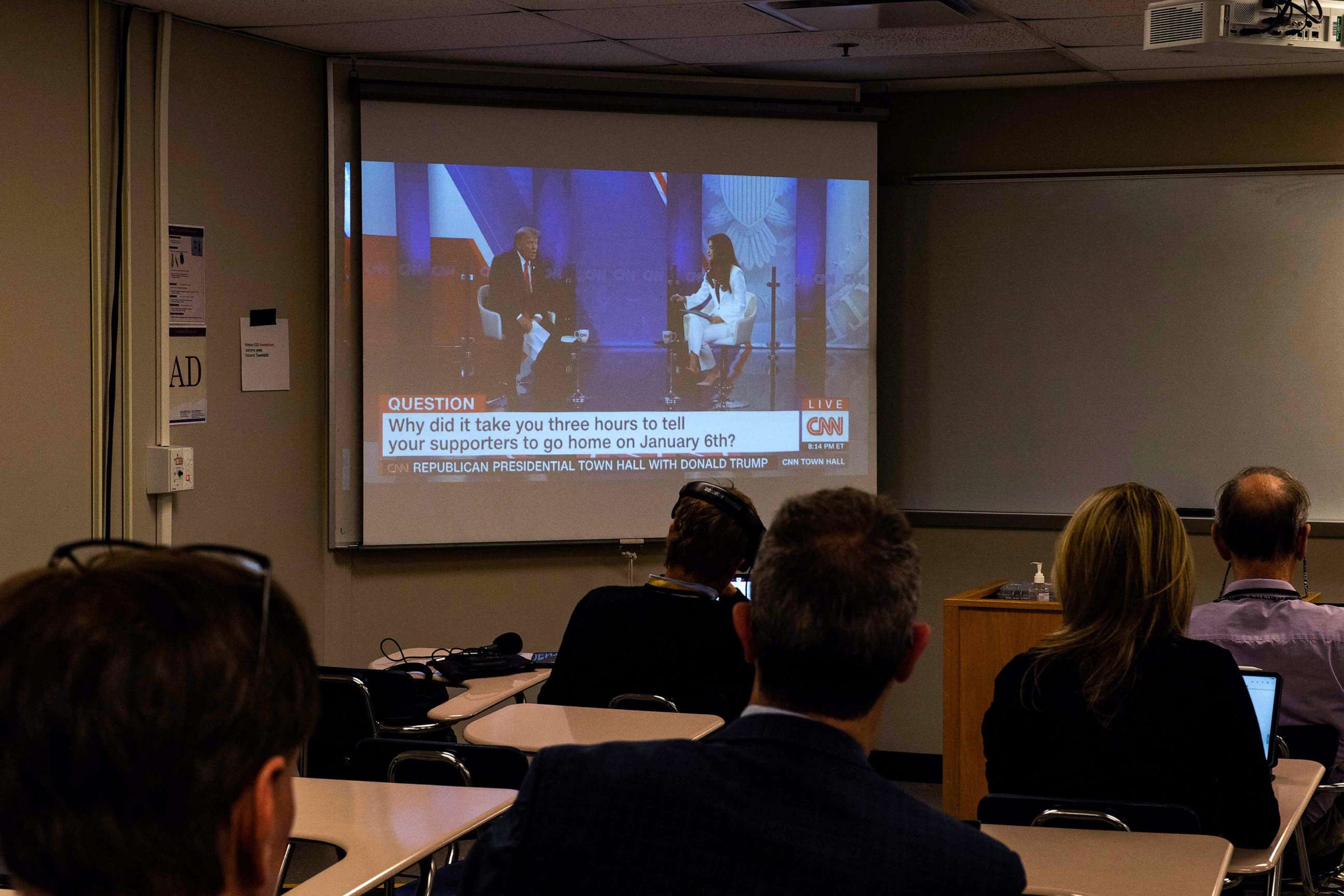 PHOTO: Reporters watch a CNN town hall with former President and 2024 Presidential hopeful Donald Trump at St. Anselm College in Manchester, New Hampshire, on May 10, 2023.