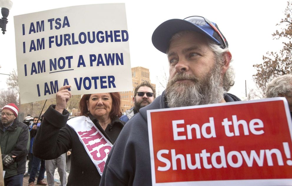 PHOTO: TSA employee Marae Persson (L) holds a sign protesting the government shutdown at the James V. Hansen Federal Building, Jan. 10, 2019 in Ogden, Utah. 