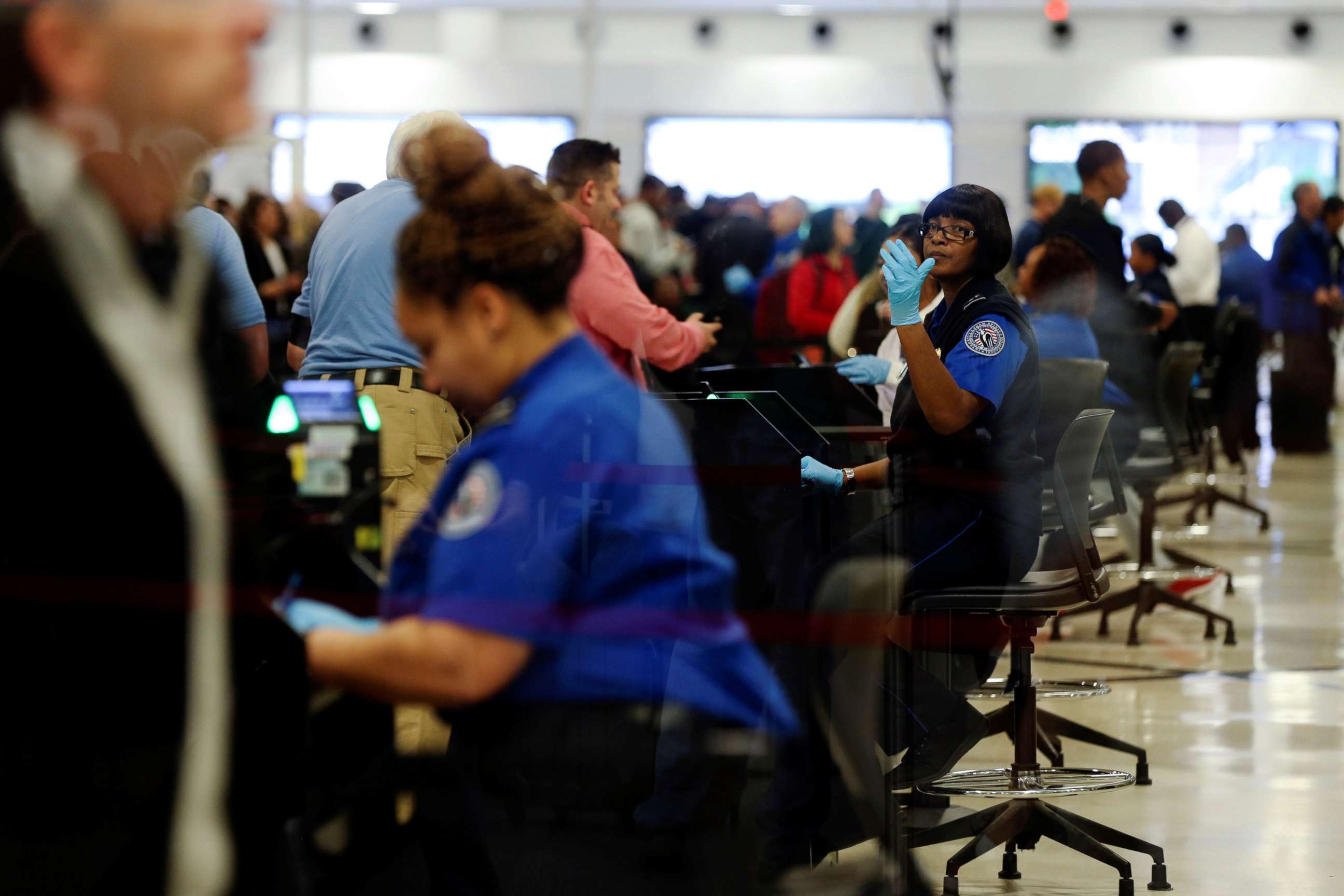 PHOTO: Transportation Security Administration (TSA) agents screen passengers at a security checkpoint at Hartsfield-Jackson Atlanta International Airport, Jan. 18, 2019.