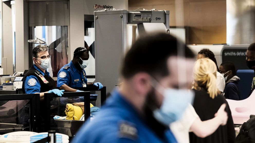 PHOTO: Transportation Security Administration (TSA) agents screen travelers at a checkpoint in the Detroit Metropolitan Wayne County Airport (DTX) in Romulus, Michigan, June 12, 2021.