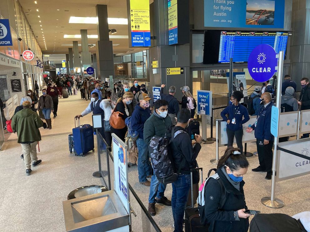 PHOTO: Travelers stand in line at a TSA security checkpoint at Austin-Bergstrom International Airport on Feb. 19, 2021, in Austin, Texas.