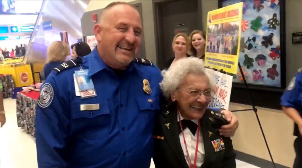 PHOTO: Lt. Colonel Maggie DeSanti does push-ups alongside TSA agent before boarding Honor Flight in Arizona.