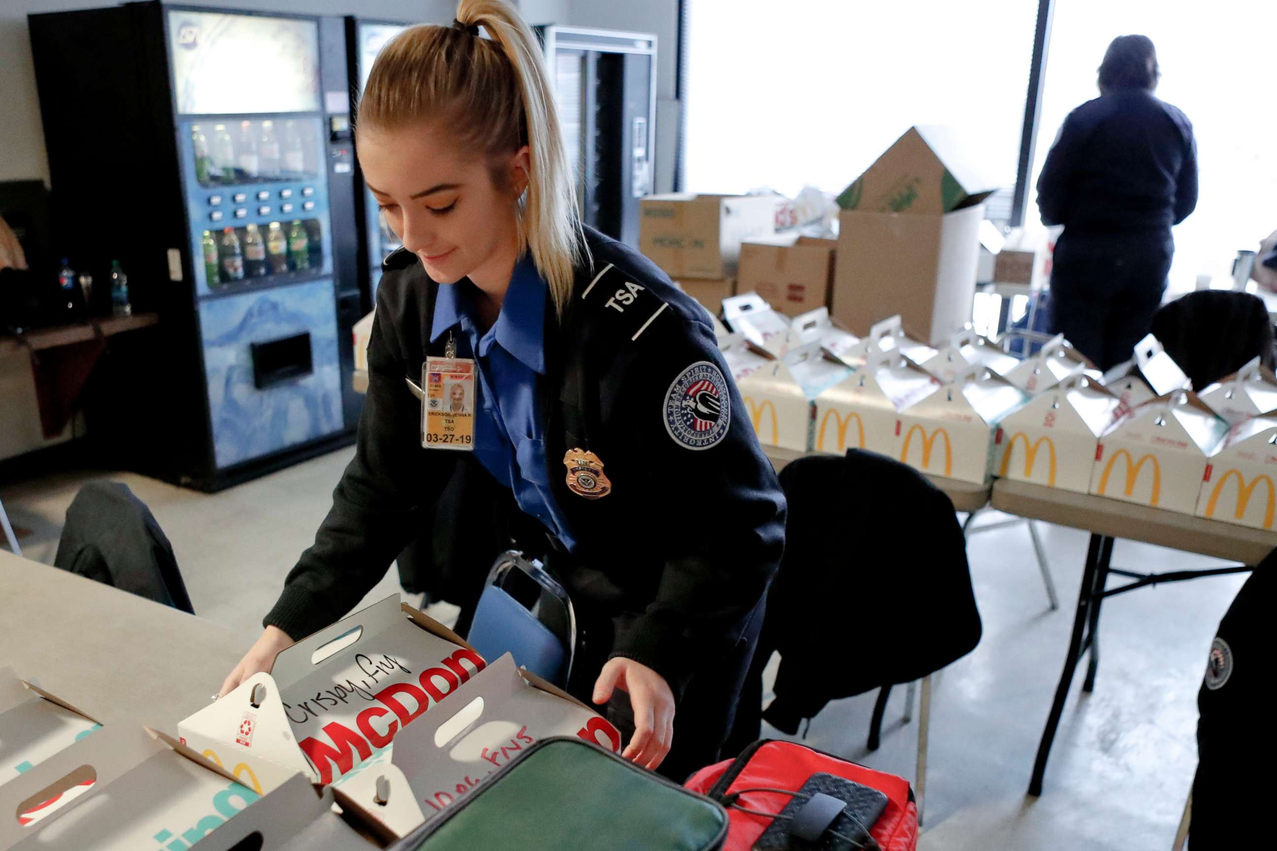 PHOTO: TSA officer Jenna Erickson, left, helps arrange boxes of meals at the TSA break room, Jan. 18, 2019, at the Pittsburgh International Airport in Imperial, Pa.