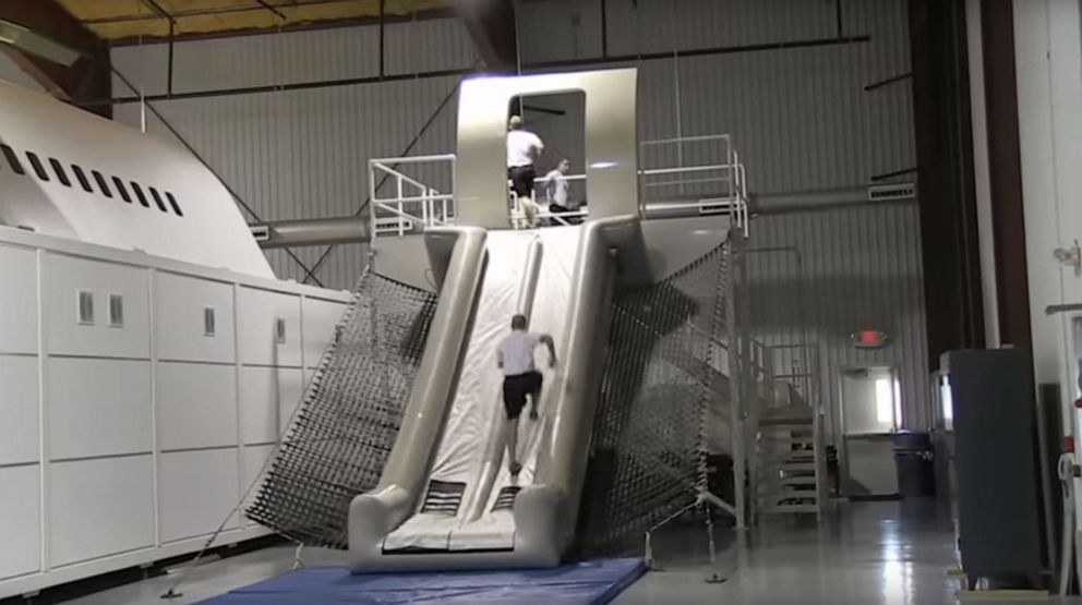 PHOTO: A Federal Air Marshal Service trainee runs up an inflatable evacuation slide.