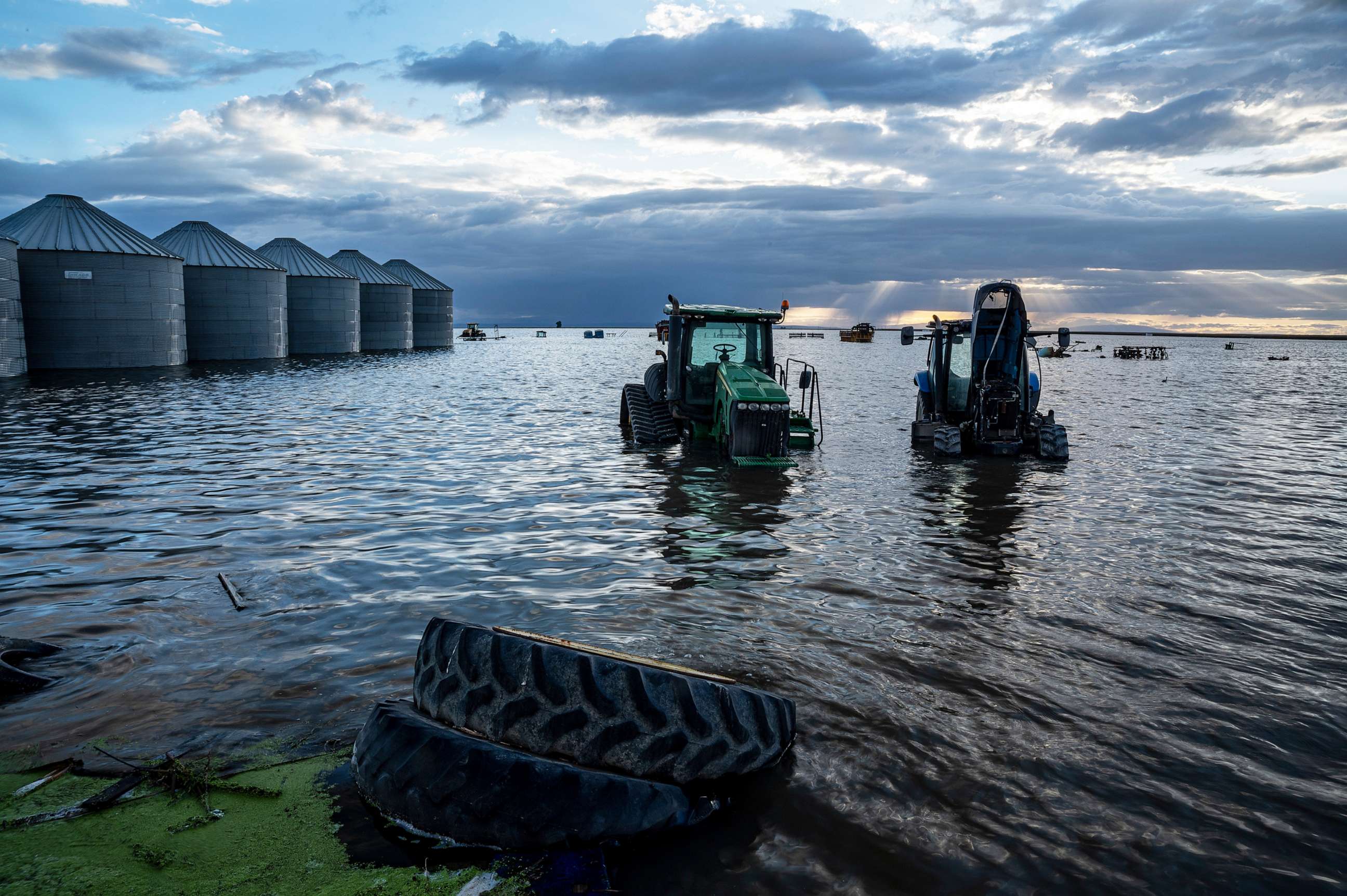 PHOTO: Ranch equipment stand in floodwaters from the reemerging Tulare Lake near Corcoran, Calif., on May 1, 2023.