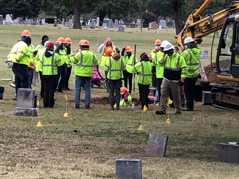 PHOTO: A work crew examines a grave containing what may be the remains of victims of the 1921 Tulsa Race Massacre, at Oaklawn Cemetery in Tulsa, Okla., Oct. 21, 2020.