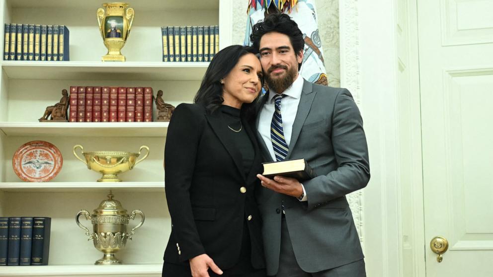 PHOTO: Tulsi Gabbard and her husband Abraham Williams hug before she is sworn in in as Director of National Intelligence (DNI) in the Oval Office of the White House in Washington, Feb. 12, 2025. 