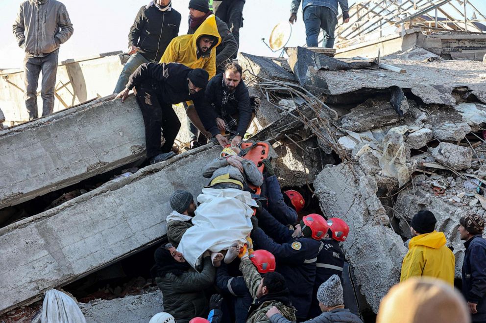 PHOTO: Rescue workers pull out a survivor from the rubble of a destroyed building in Kahramanmaras, southern Turkey, a day after a 7.8-magnitude earthquake struck the country's southeast, on Feb. 7, 2023.