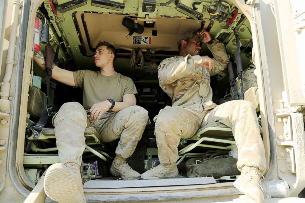 PHOTO: U.S. Army Spc. James Turner (left) and 1st Lt. Justin Rodgers, assigned to 5th Squadron, 4th Cavalry Regiment, 2nd Armored Brigade Combat Team, performs a check on an M113 Armoured Personnel Carrier in Grafenwoehr, Germany, April 21, 2018.