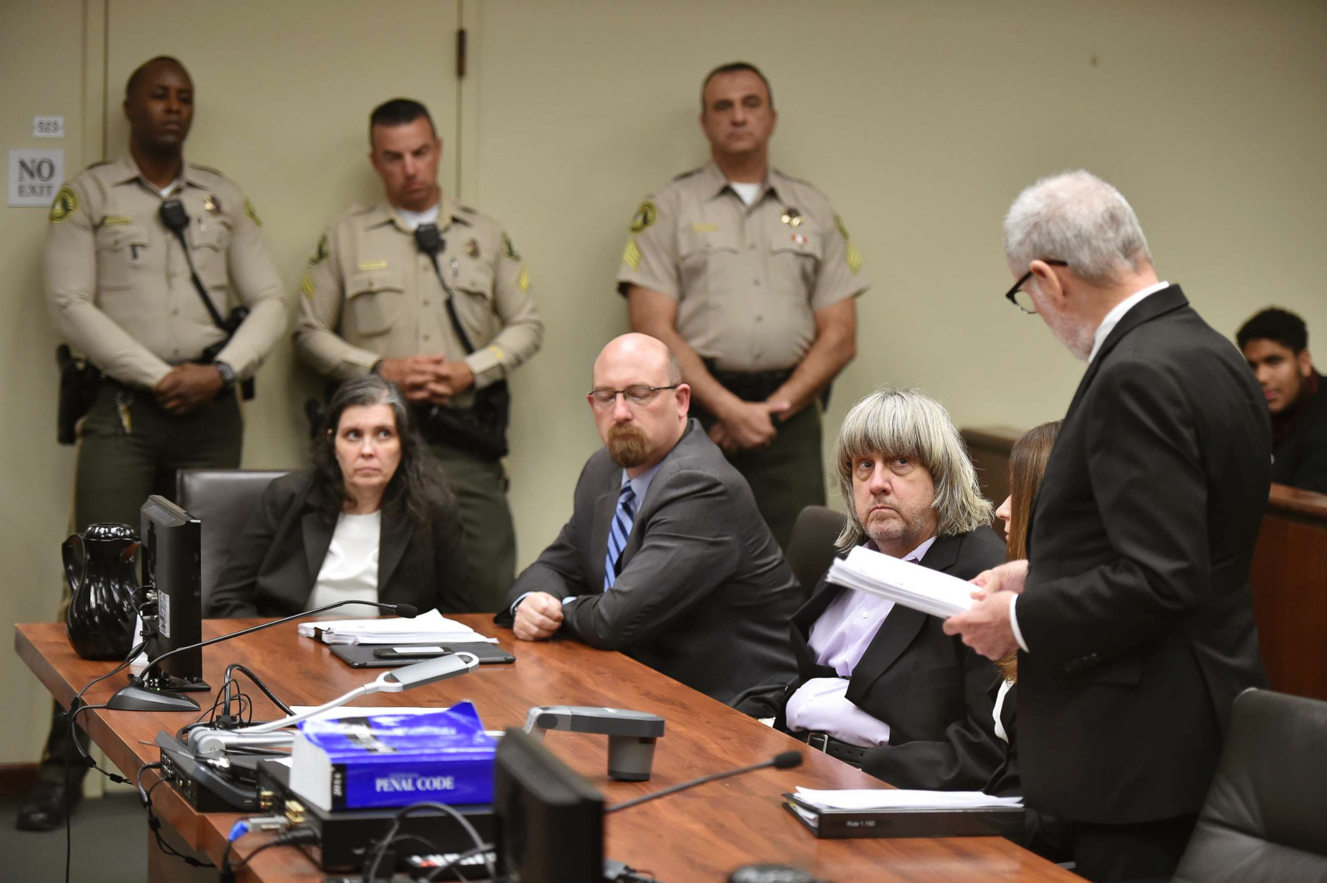 PHOTO: Louise Anna Turpin, far left, with attorney Jeff Moore, center, and her husband David Allen Turpin, listen to attorney, David Macher, as they appear in court for their arraignment in Riverside, Calif., Jan. 18, 2018.