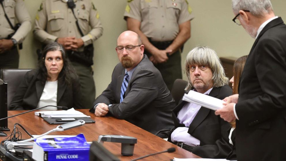 PHOTO: Louise Anna Turpin, far left, with attorney Jeff Moore, center, and her husband David Allen Turpin, listen to attorney, David Macher, as they appear in court for their arraignment in Riverside, Calif., Jan. 18, 2018.