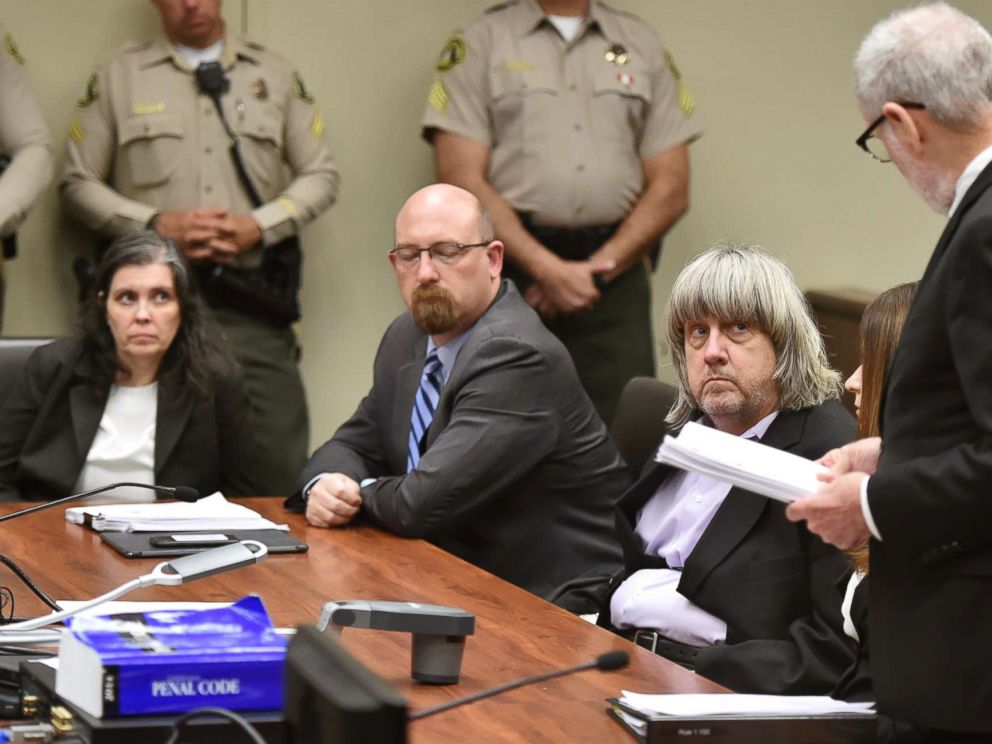 PHOTO: Louise Anna Turpin, far left, with attorney Jeff Moore, center, and her husband David Allen Turpin, listen to attorney, David Macher, as they appear in court for their arraignment in Riverside, Calif., Jan. 18, 2018.