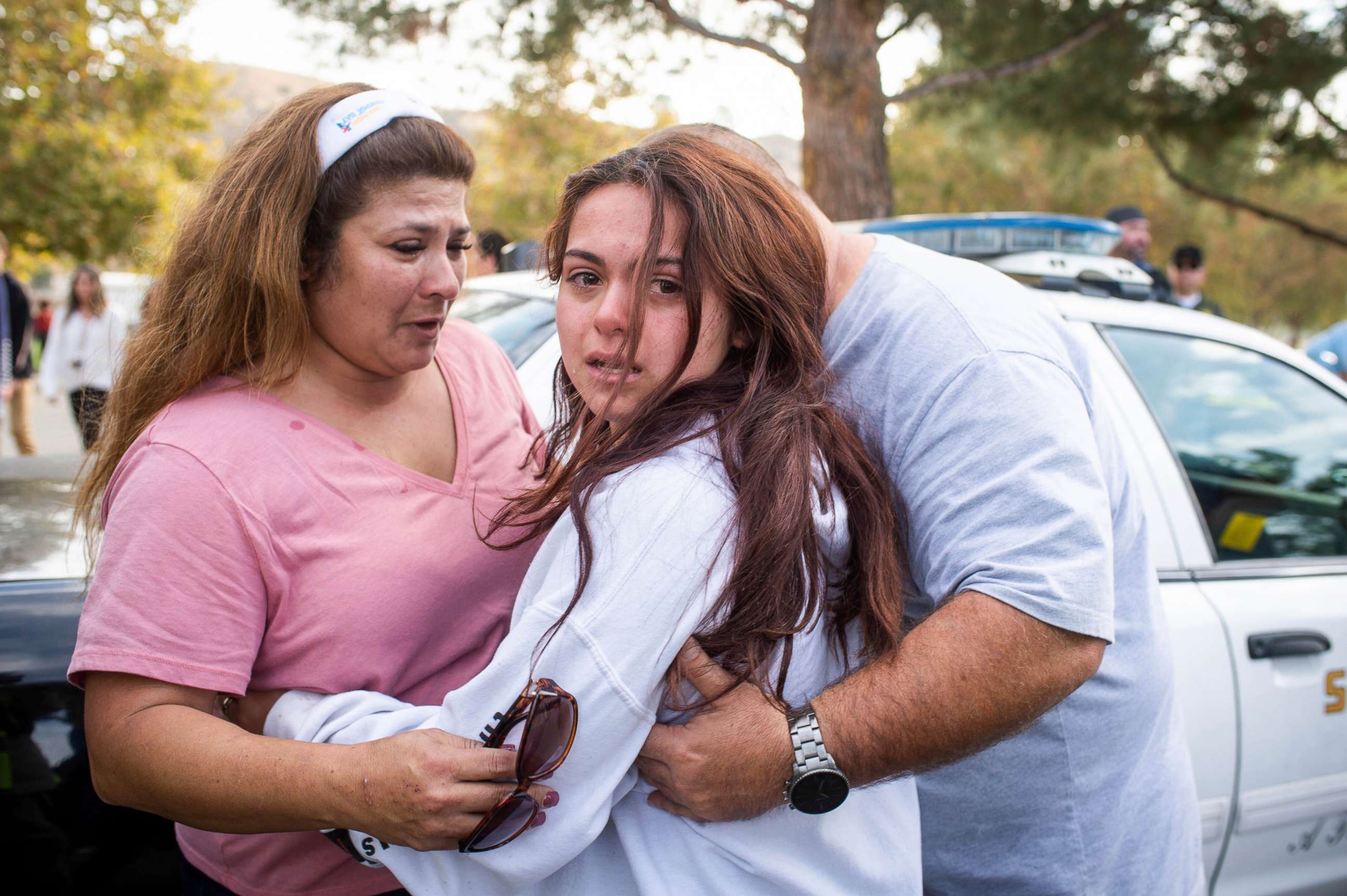 PHOTO: A student reunites with her parents after a school shooting in Santa Clarita, Calif.