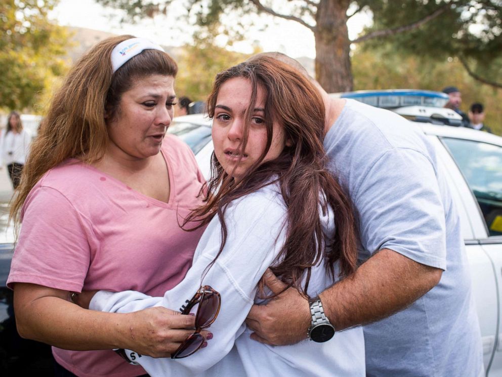 PHOTO: A student reunites with her parents after a school shooting in Santa Clarita, Calif.