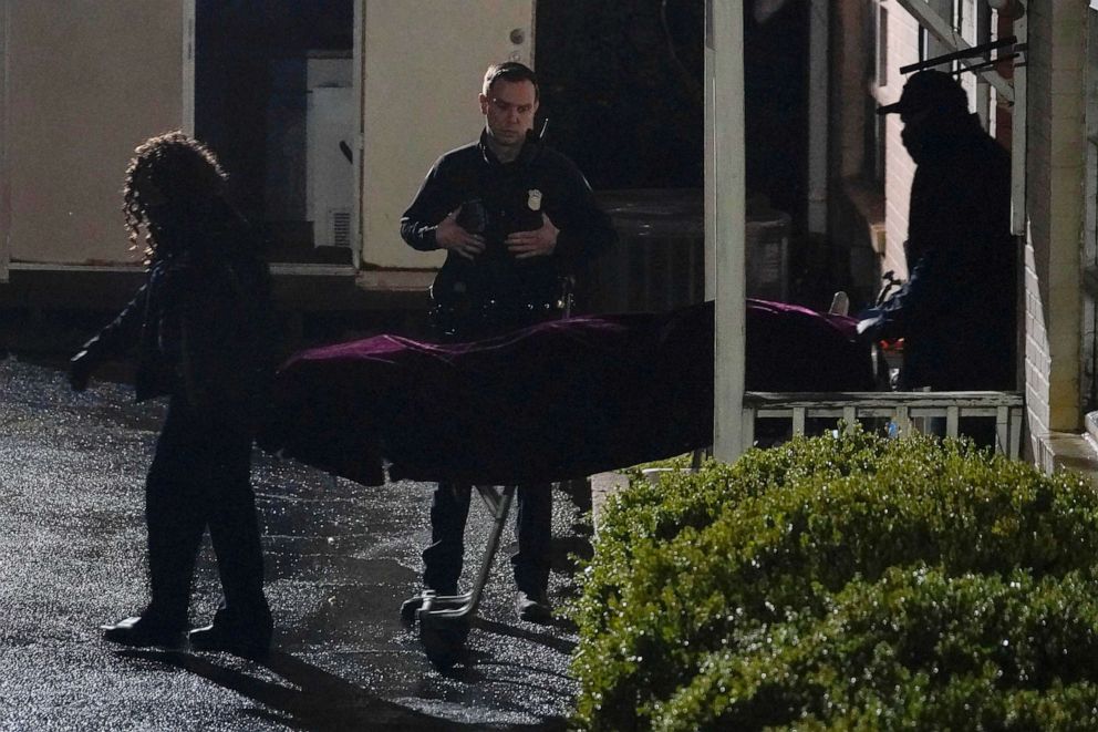 PHOTO: A police officer watches as a body is taken from the Gold Spa massage parlor after a shooting, March 16, 2021, in Atlanta.