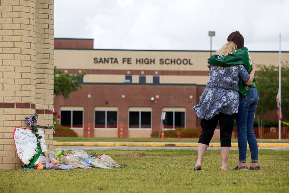 PHOTO: Senior Amy Roden and her grandmother Gail embrace at a makeshift memorial for shooting victims outside Santa Fe High School in Santa Fe, Texas, May 20, 2018.