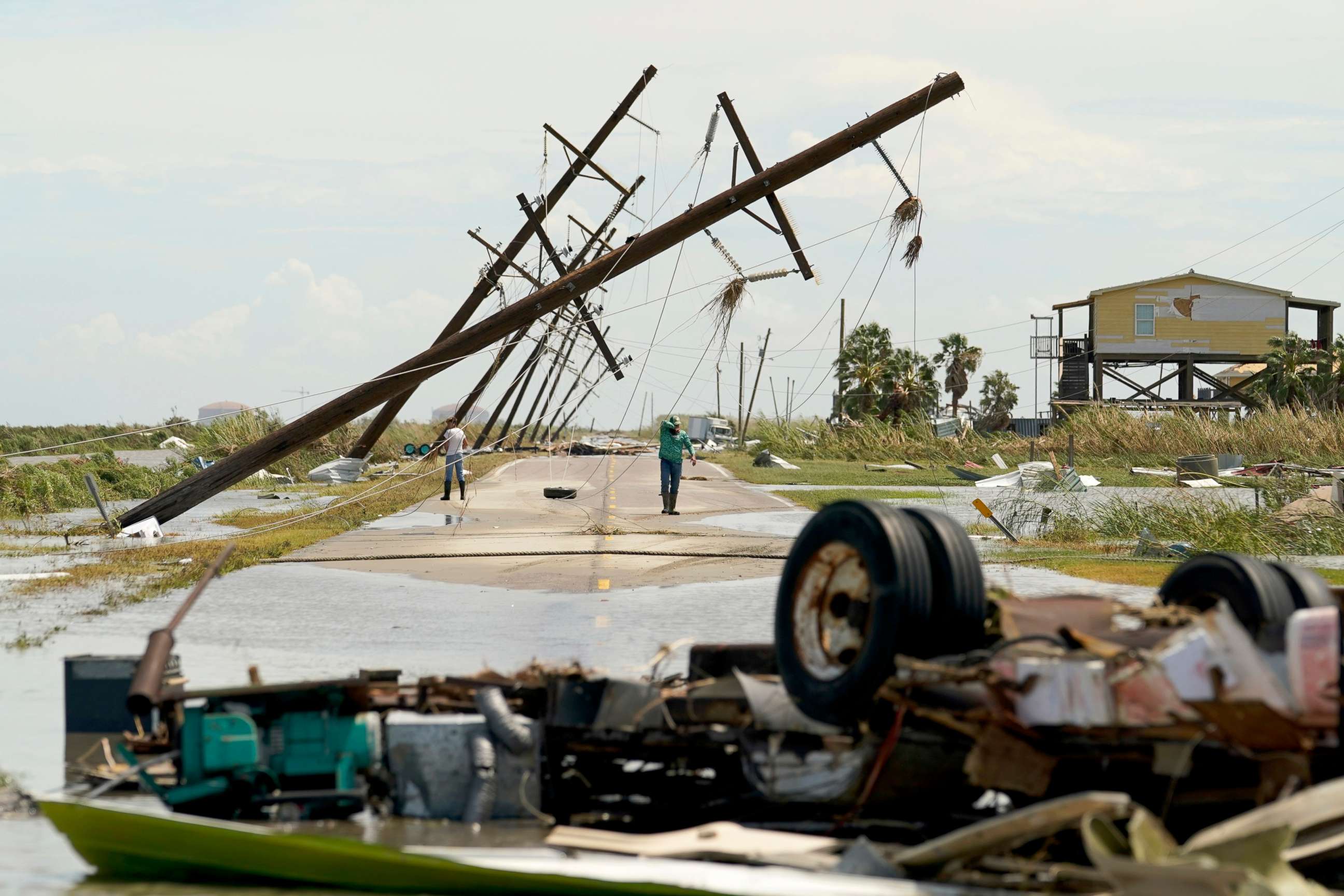 PHOTO: People survey the damage to their homes left in the wake of Hurricane Laura, Aug. 27, 2020, in Holly Beach, La.