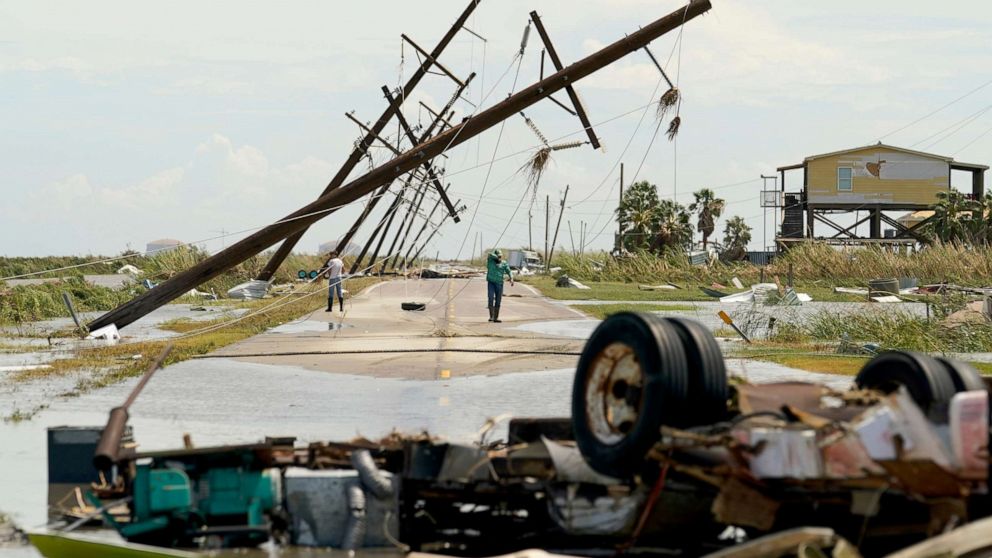 PHOTO: People survey the damage to their homes left in the wake of Hurricane Laura, Aug. 27, 2020, in Holly Beach, La.