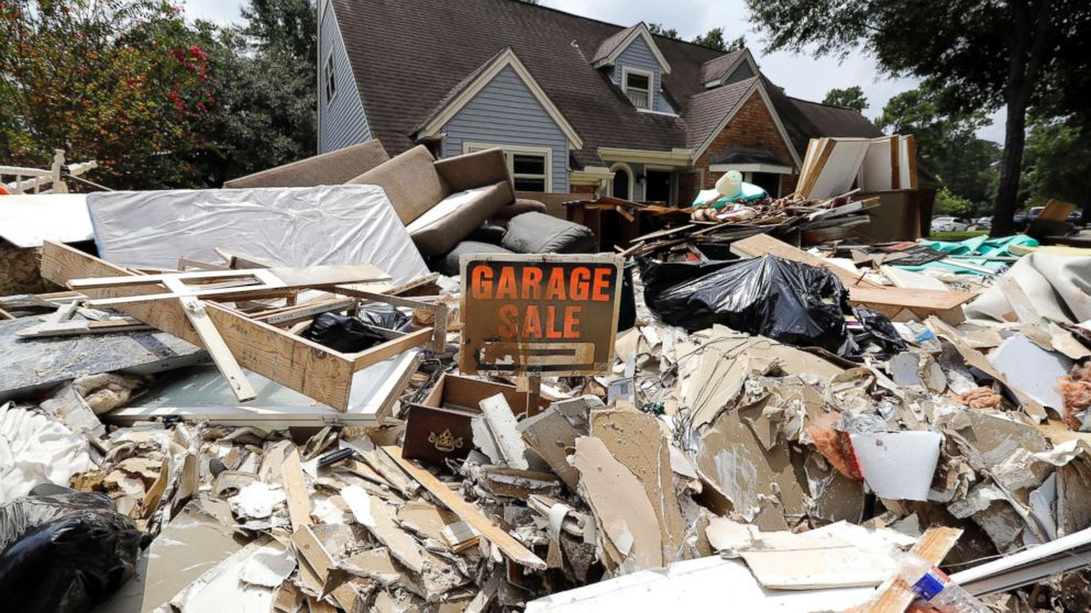 PHOTO: A garage sale sign stands in a pile of debris damaged by floodwaters in the aftermath of Hurricane Harvey in Spring, Texas, Sept. 3, 2017.