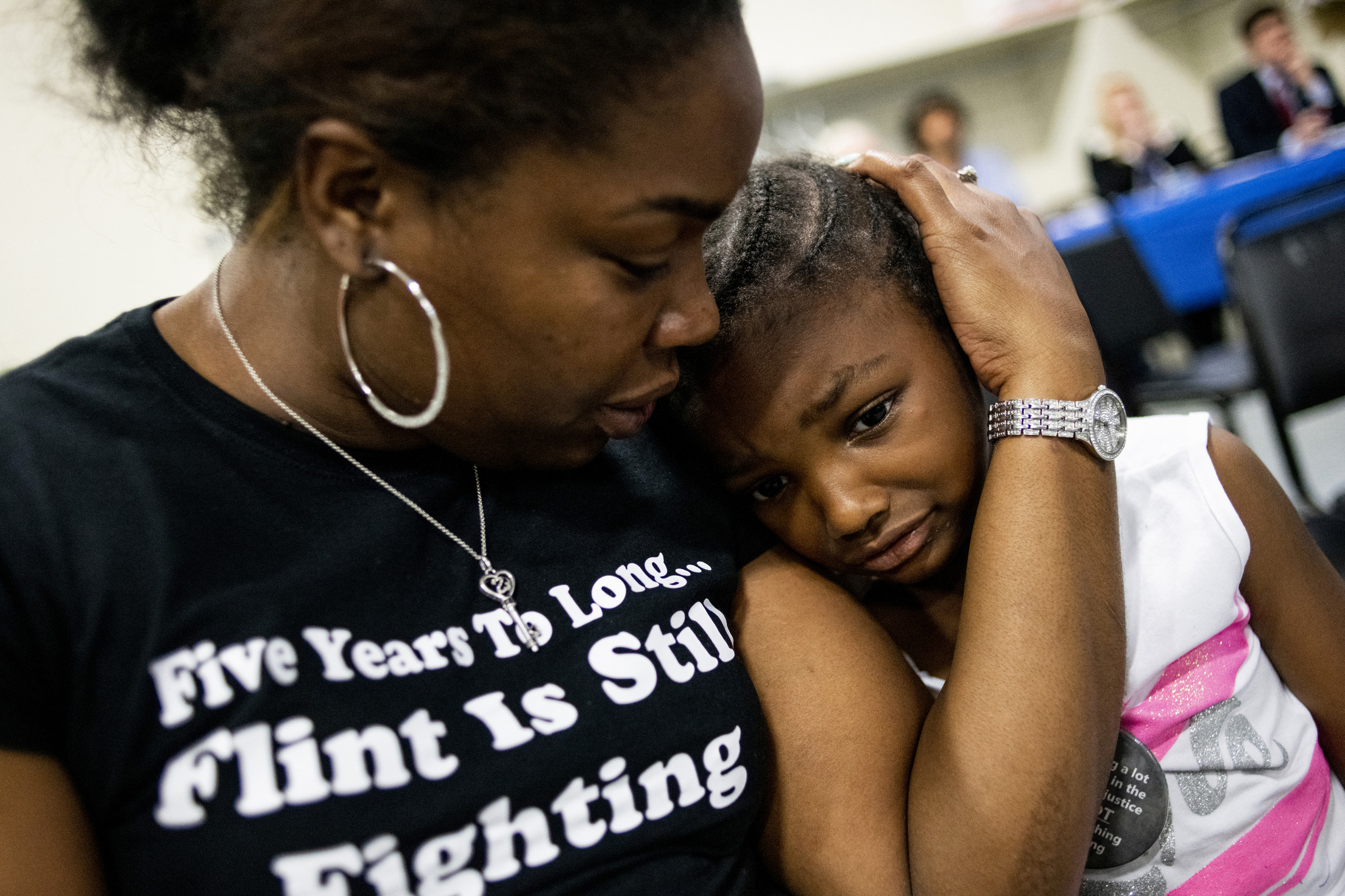 PHOTO: Flint resident Ariana Hawk consoles her daughter Aliana, 4, near the end of a two-hour community meeting with Flint water prosecutors at UAW Local 659, June 28, 2019, in Flint, Michigan. 