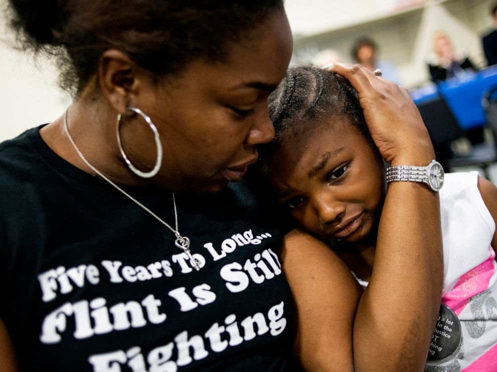 PHOTO: Flint resident Ariana Hawk consoles her daughter Aliana, 4, near the end of a two-hour community meeting with Flint water prosecutors at UAW Local 659, June 28, 2019, in Flint, Michigan.