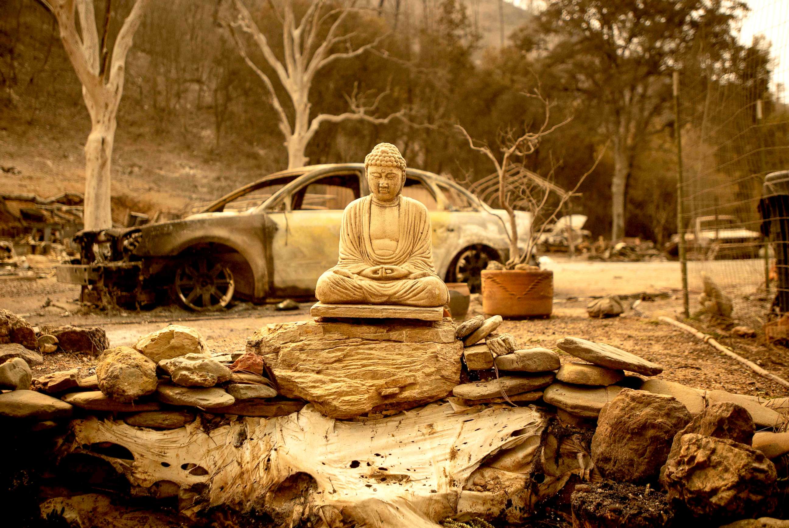 PHOTO: A statue of the Buddha is seen at a burned home near Clearlake Oaks, California, Aug. 7, 2018. The raging Mendocino Complex fire comprising twin blazes in the western state's north has now ravaged more than 290,000 acres.