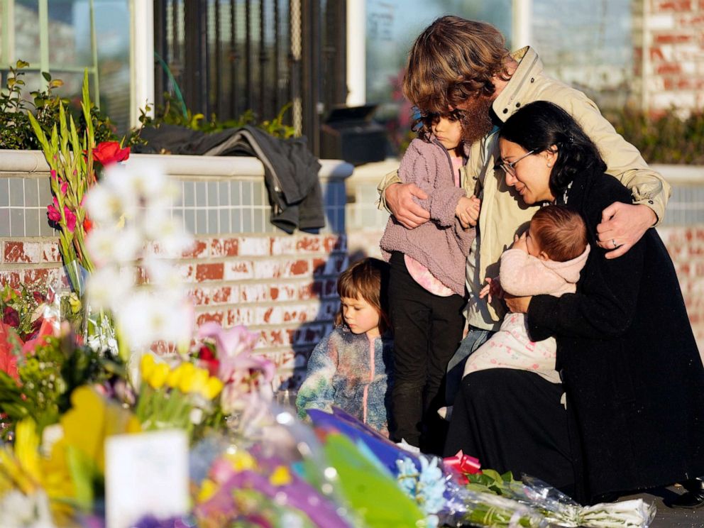 PHOTO: After a mass shooting, a family gathers at a memorial outside the Star Ballroom Dance Studio, Jan. 24, 2023, in Monterey Park, Calif.