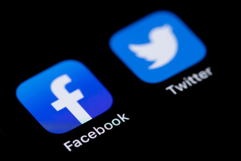 PHOTO: The Facebook und Twitter logos on the screen of an iPhone, March 9, 2021.