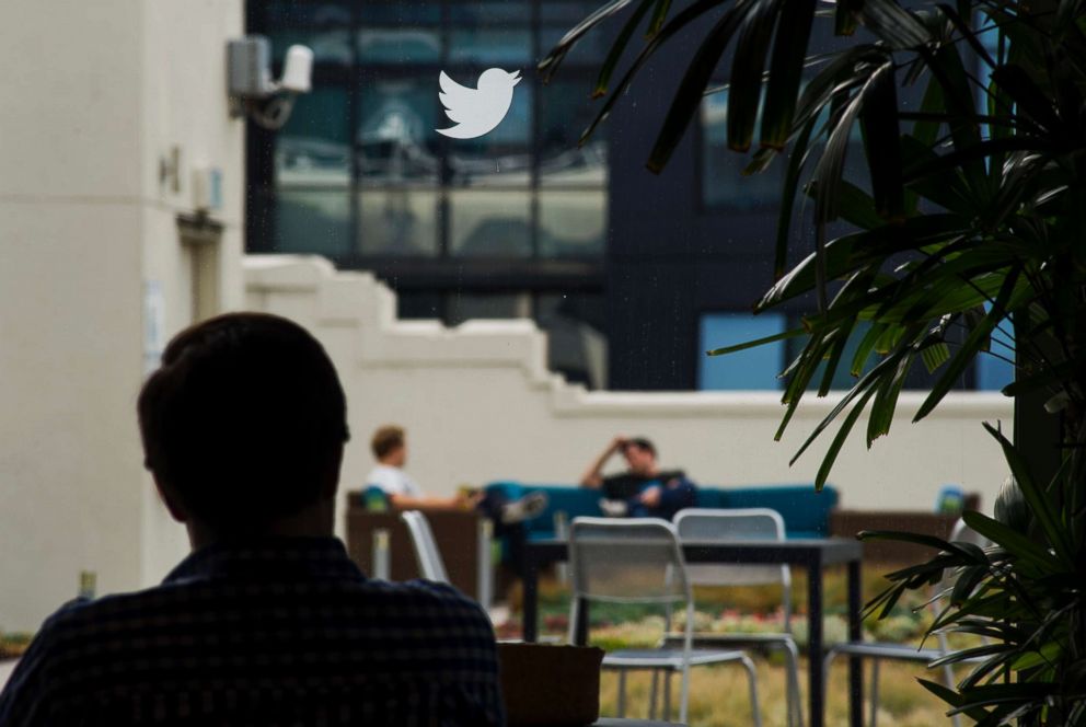 PHOTO: An employee is seen beneath the Twitter Inc. logo in the cafeteria area of the company's headquarters in San Francisco, Calif., Sept. 19, 2014.