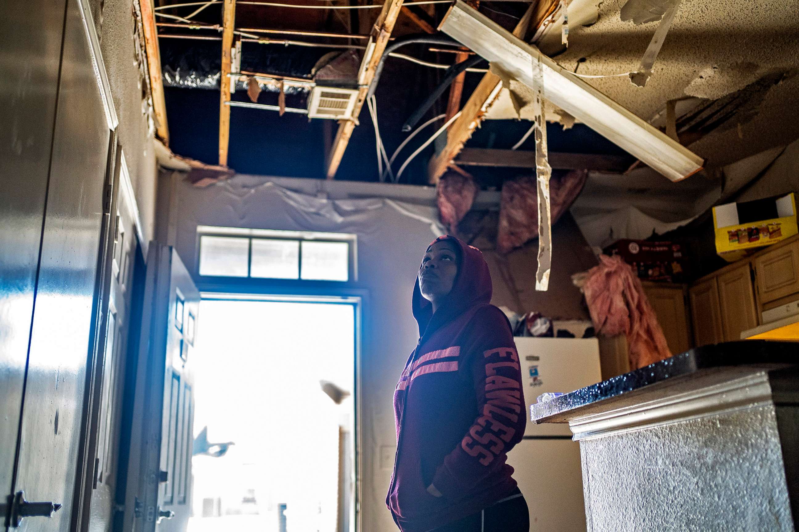 PHOTO: Suzanne Mitchel, looks at her water damaged ceiling in Dallas on Feb. 19, 2021. As power was restored, Texans confronted another crisis: A shortage of drinkable water as pipes cracked, wells froze and water treatment plants were knocked offline. 