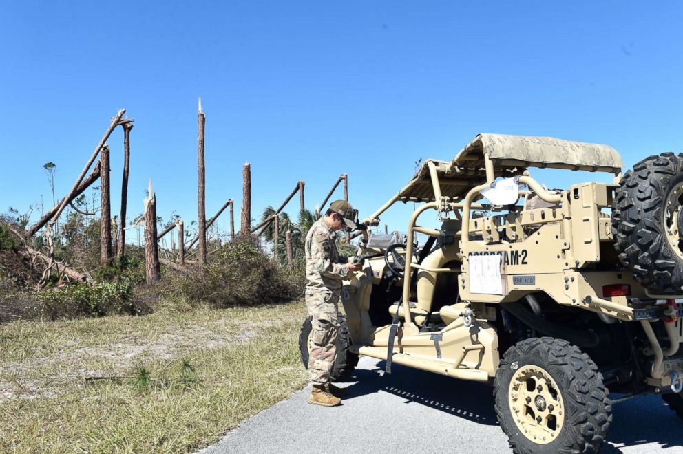 PHOTO: Tech. Sgt. Elizabeth Berreles, 921st Contingency Response Squadron security forces, performs an initial security assessment of the area at Tyndall Air Force Base, Florida, Oct. 12, 2018.