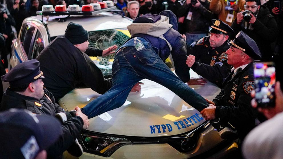 PHOTO: Police officers try to remove a protestor from a police vehicle, on the day of the release of a video showing police officers beating Tyre Nichols during a traffic stop by Memphis police officers, in New York, Jan. 27, 2023.