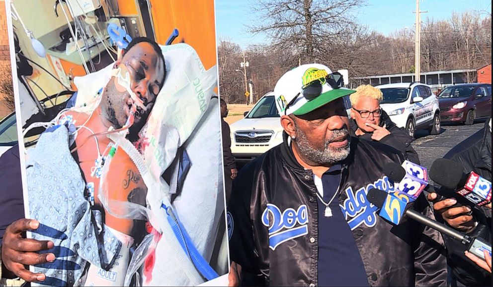 PHOTO: In this photo provided by WREG, Tyre Nichols' stepfather Rodney Wells, right, holds a photo of Nichols in the hospital after his arrest, during a protest in Memphis, Tenn., Saturday, Jan. 14, 2023.