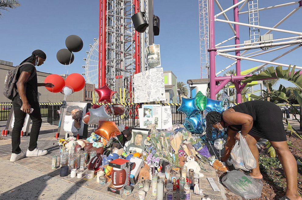 PHOTO: Family members and friends of Tyre Sampson leave items during a vigil in front of the Orlando Free Fall drop tower in ICON Park in Orlando, on March 28, 2022.