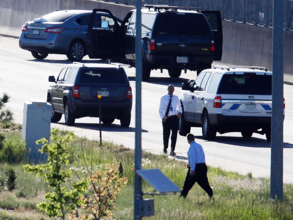 PHOTO: Denver Police Department detectives, investigate near where a Nissan sedan, top left, being driven by an Uber driver crashed into a retaining wall along Interstate 25 south of downtown Denver, June 1, 2018.