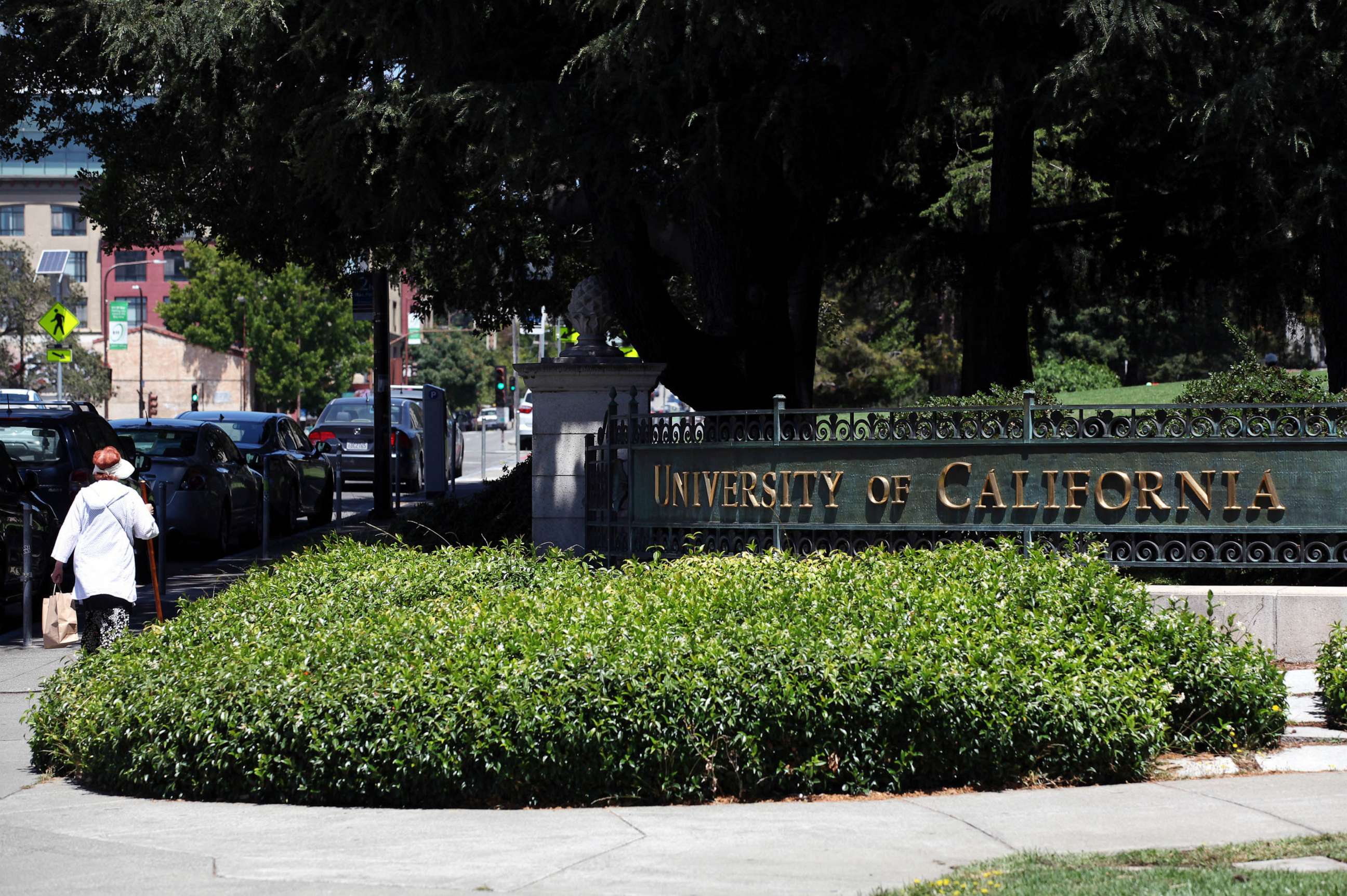 PHOTO: FILE - A pedestrian walks by a sign in front of the U.C. Berkeley campus, July 22, 2020 in Berkeley, Calif.