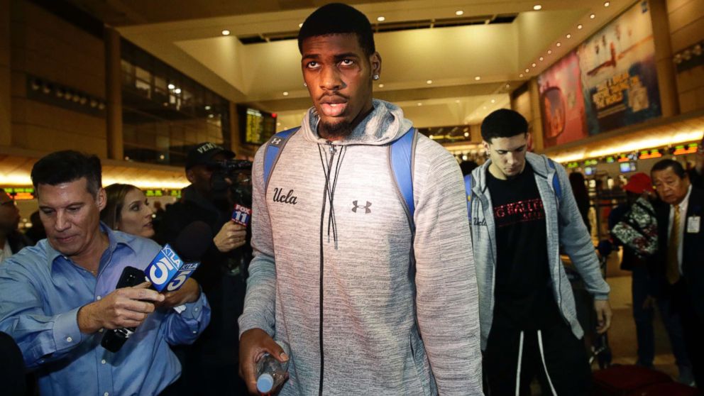 PHOTO: UCLA basketball players Cody Riley, center, and LiAngelo Ball, background right, are followed by the media as they leave Los Angeles International Airport, Nov. 14, 2017, in Los Angeles. 