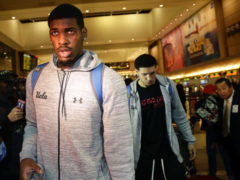 PHOTO: UCLA basketball players Cody Riley, center, and LiAngelo Ball, background right, are followed by the media as they leave Los Angeles International Airport, Nov. 14, 2017, in Los Angeles.