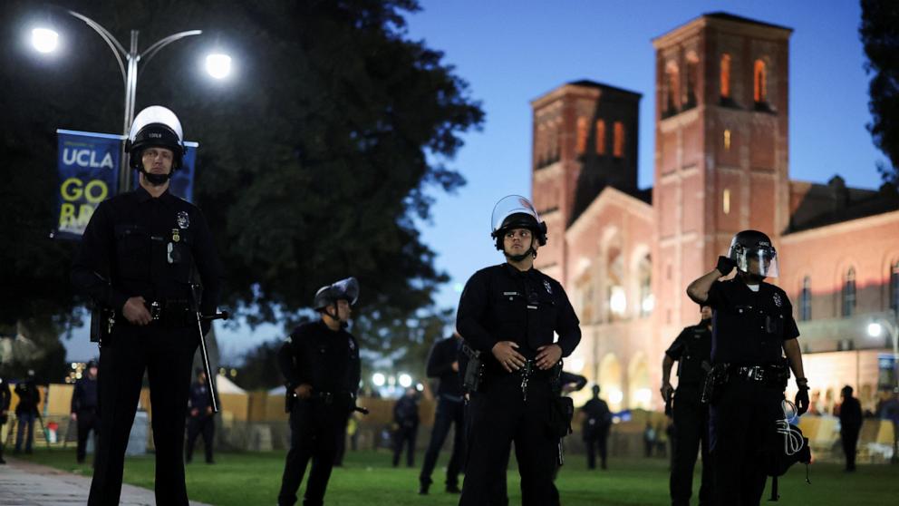 PHOTO :Law enforcement officers take position before entering the pro-Palestinian protest encampment at the University of California Los Angeles on May 1, 2024.