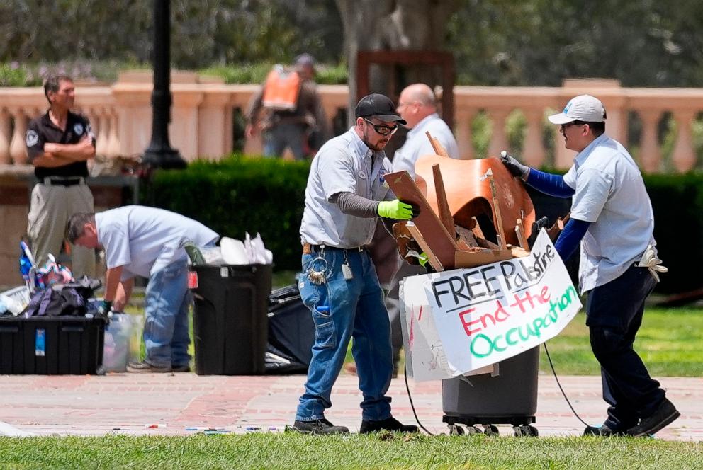 PHOTO: Signs and other debris are removed at the site of a pro-Palestinian encampment which was cleared by police overnight on the UCLA campus Thursday, May 2, 2024, in Los Angeles.