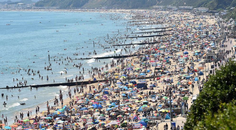 PHOTO: Beachgoers enjoy the sunshine as they sunbathe and play in the sea on Bournemouth beach in Bournemouth, southern England, on June 25, 2020.