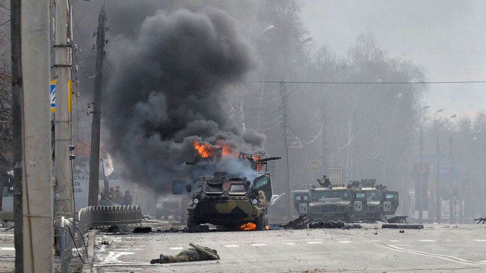 PHOTO: A Russian Armoured personnel carrier burns during a fight with the Ukrainian armed forces in Kharkiv, Feb. 27, 2022.