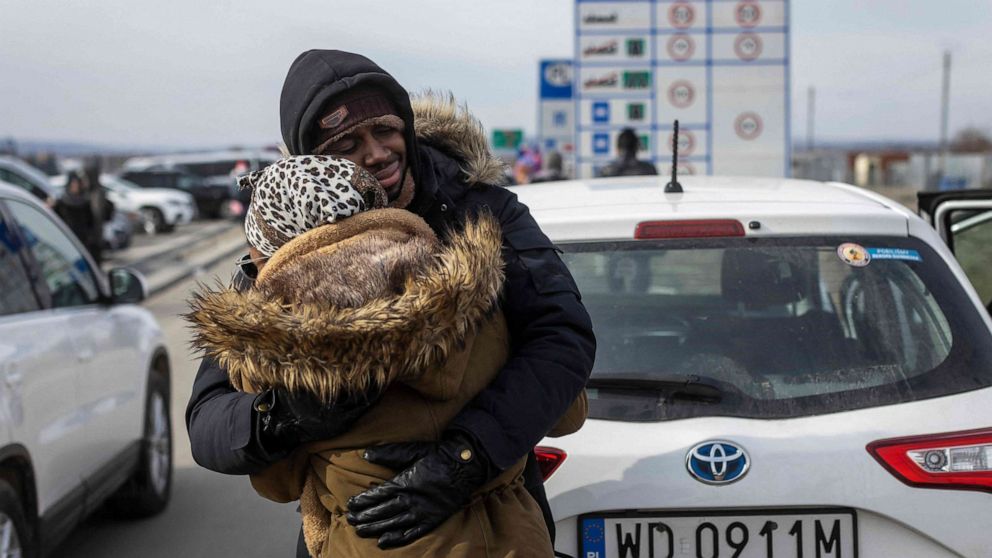 PHOTO: Refugees arriving from Ukraine embrace at the border crossing in Medyka, eastern Poland on March 1, 2022.