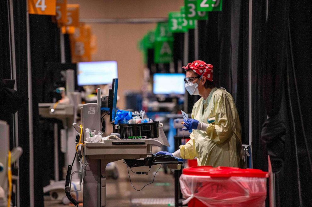 PHOTO: Inside the hot zone medical staff monitor and treat sick patients infected with the Covid-19 virus at the UMASS Memorial DCU Center Field Hospital in Worcester, Massachusetts, Jan. 13, 2021.