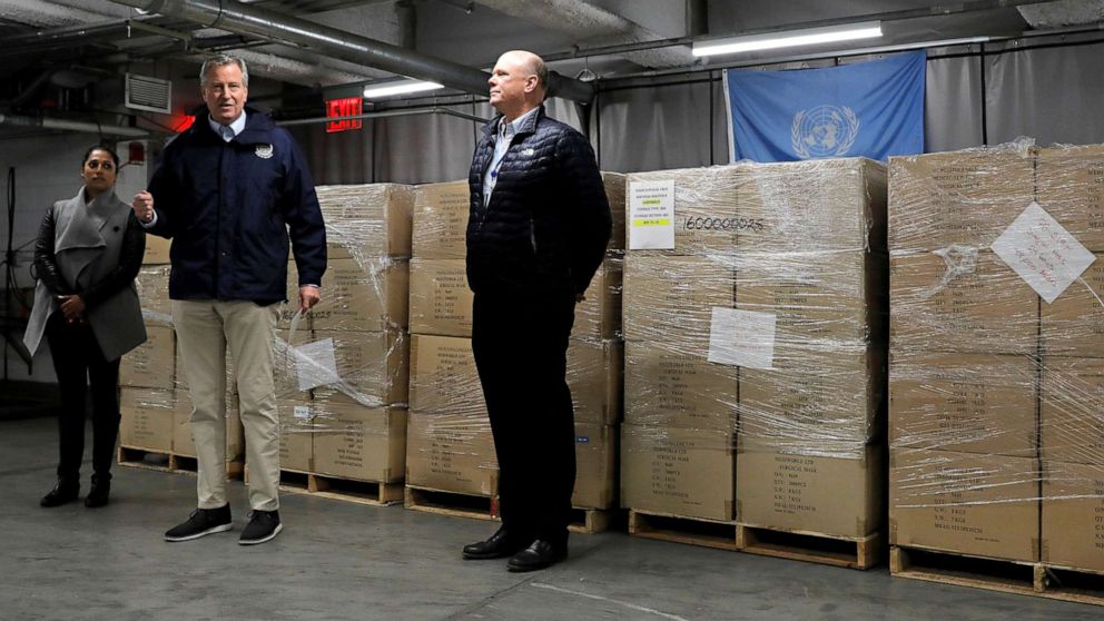 PHOTO: New York City Mayor Bill de Blasio, center, addresses media while accepting 250,000 face masks donated to city health workers by the United Nations, to help with the COVID-19 pandemic, at UN Headquarters in New York City, March 28, 2020.