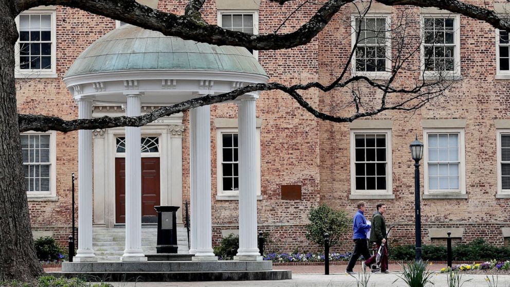 PHOTO: In this March 18, 2020 file photo, people remove belongings on campus at the University of North Carolina in Chapel Hill, N.C.